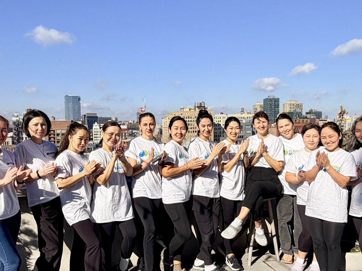 The Cleaning Master team of professional cleaners on a rooftop with the New York skyline